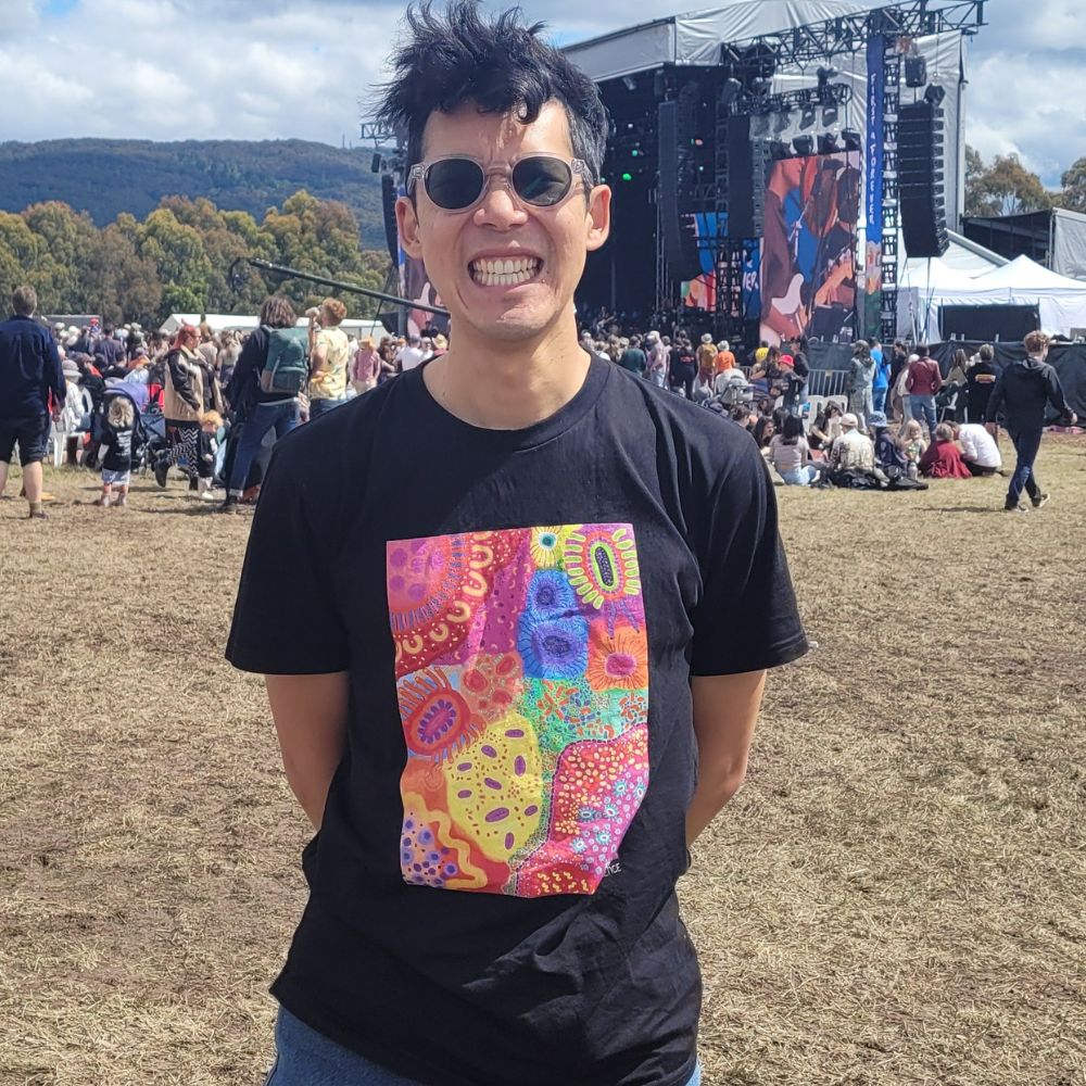 man smiling at music festival in balance shirt design