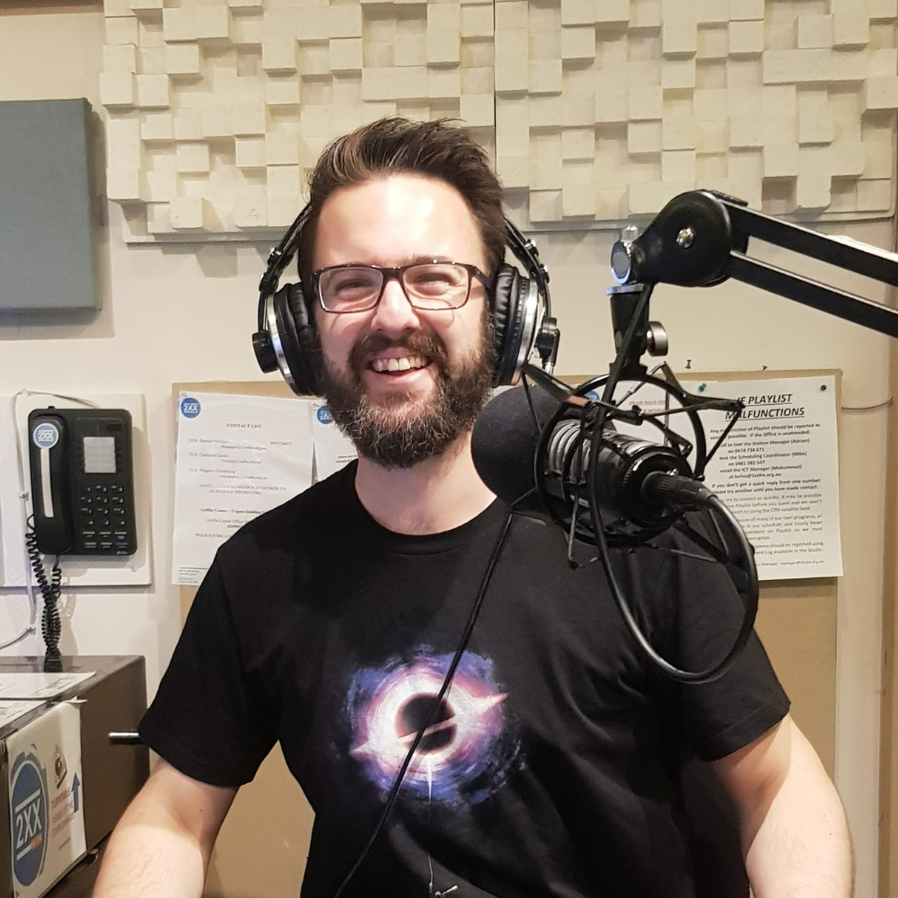 man in a radio studio wearing Team Balloons shirt